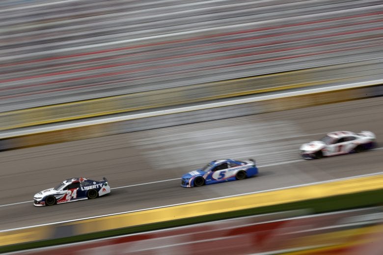LAS VEGAS, NEVADA - MARCH 07: William Byron, driver of the #24 Liberty University Chevrolet, leads Kyle Larson, driver of the #5 HendrickCars.com Chevrolet, and Denny Hamlin, driver of the #11 FedEx Ground Toyota, during the NASCAR Cup Series Pennzoil 400 presented by Jiffy Lube at the Las Vegas Motor Speedway on March 07, 2021 in Las Vegas, Nevada. (Photo by Chris Graythen/Getty Images) | Getty Images