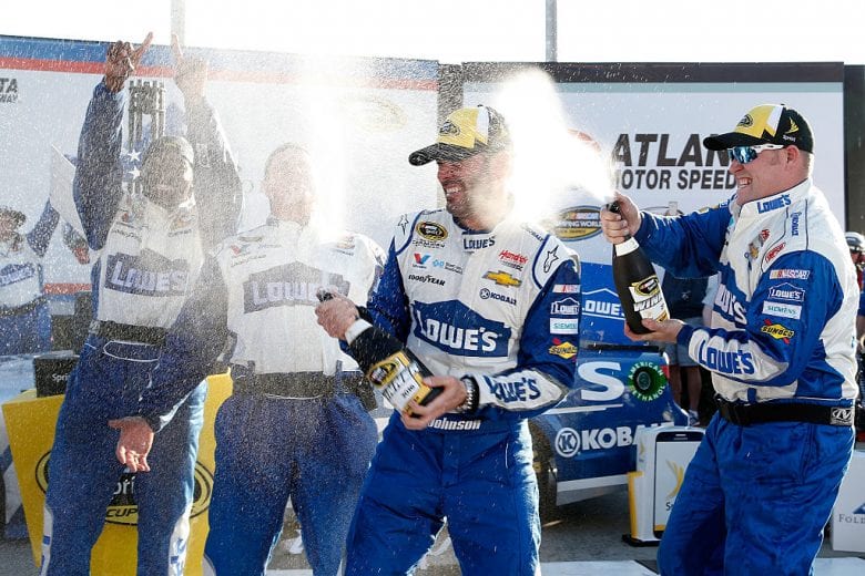 HAMPTON, GA - FEBRUARY 28:  Jimmie Johnson, driver of the #48 Lowe's Chevrolet, celebrates with champagne in Victory Lane after winning the NASCAR Sprint Cup Series Folds of Honor QuikTrip 500 at Atlanta Motor Speedway on February 28, 2016 in Hampton, Georgia.  (Photo by Brian Lawdermilk/Getty Images) | Getty Images