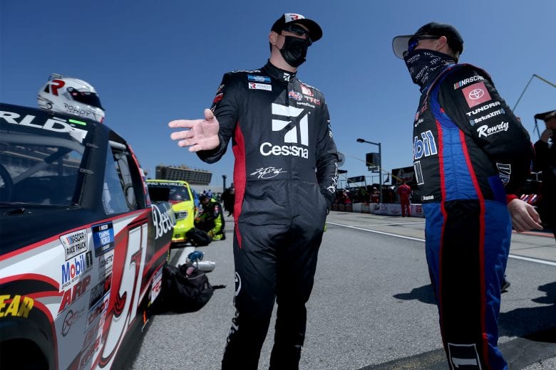 HAMPTON, GEORGIA - MARCH 20: Kyle Busch, driver of the #51 Cessna Toyota, and John Hunter Nemechek, driver of the #4 Mobil 1 Toyota, talk on the grid prior to the NASCAR Camping World Truck Series Fr8Auctions 200 at Atlanta Motor Speedway on March 20, 2021 in Hampton, Georgia. (Photo by Sean Gardner/Getty Images) | Getty Images
