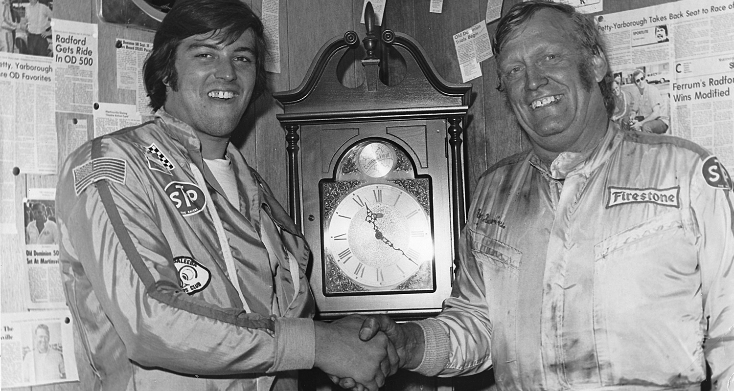 MARTINSVILLE, VA — October 27, 1974: After winning their respective races in the Cardinal 500 Classic at Martinsville Speedway, Ron Bouchard (L) and Ray Hendrick (R) pose with one of the grandfather clocks that are awarded to the victors. Bouchard won the NASCAR Modified portion of the event, while Hendrick took home the win in the NASCAR Late Model Sportsman race. (Photo by ISC Images & Archives via Getty Images)
