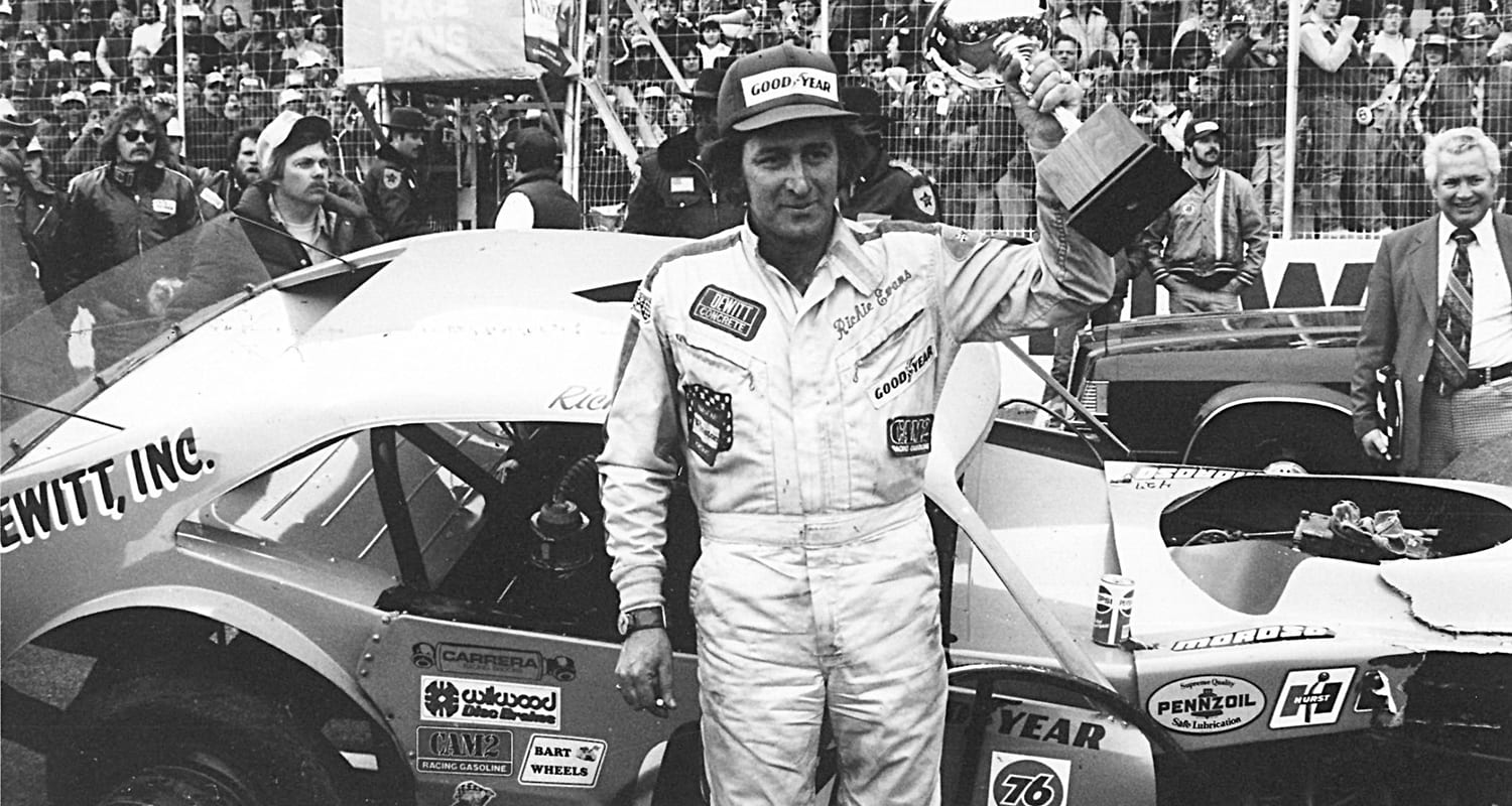 MARTINSVILLE, VA - 1981: Although his car is a bit the worse for wear, NASCAR Modified driver Richie Evans raises another trophy after an obviously hard-fought victory over Geoff Bodine in the most spectacular bump-and-grind finish at the track. (Photo by ISC Images & Archives via Getty Images)