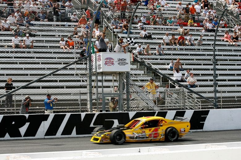 MARTINSVILLE, VA - JUNE 06: Bobby Santos, driver of the #4 Mystic Missile Dodge, takes the checkered flag in the NASCAR Whelen Modified Tour Made in America Whelen 200 at Martinsville Speedway on June 6, 2010 in Martinsville, Virginia.(Tom Whitmore/Getty Images for NASCAR) | Getty Images
