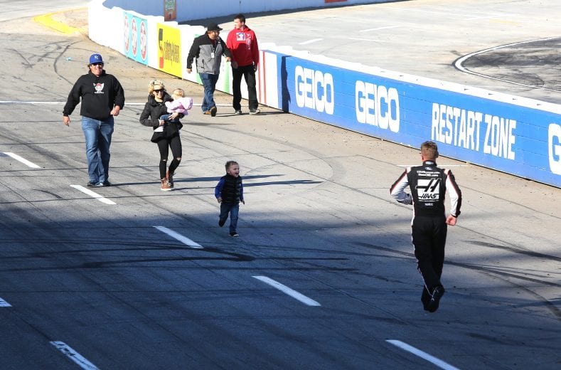 MARTINSVILLE, VA - MARCH 26:  Clint Bowyer, driver of the #14 Haas Automation Demo Day Ford, runs to greet his son, Cash, as his wife, Lorra, and their daughter Presley look on after winning the weather delayed Monster Energy NASCAR Cup Series STP 500 at Martinsville Speedway on March 26, 2018 in Martinsville, Virginia.  (Photo by Jerry Markland/Getty Images) | Getty Images