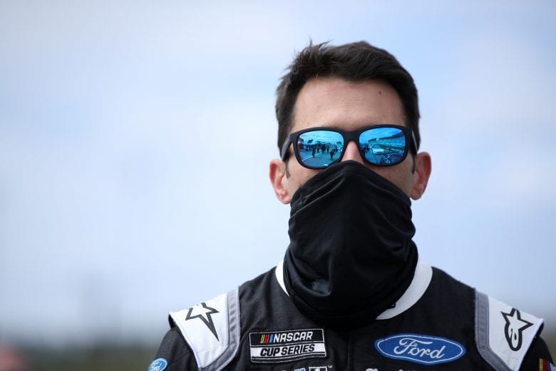HAMPTON, GEORGIA - MARCH 21: Aric Almirola, driver of the #10 Pit Boss Grills Ford, stands during the national anthem prior to the NASCAR Cup Series Folds of Honor QuikTrip 500 at Atlanta Motor Speedway on March 21, 2021 in Hampton, Georgia. (Photo by Sean Gardner/Getty Images) | Getty Images