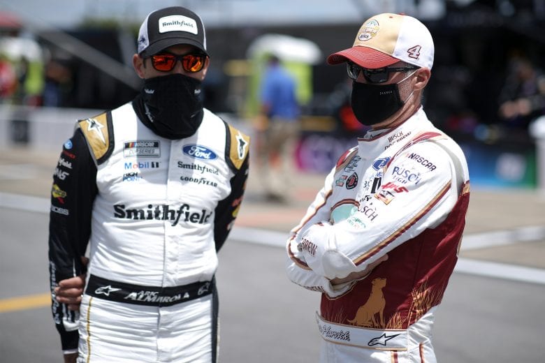 TALLADEGA, ALABAMA - APRIL 25: Kevin Harvick, driver of the #4 Busch Dog Brew Ford, and Aric Almirola, driver of the #10 Smithfield Ford, talk on the grid prior to the NASCAR Cup Series GEICO 500 at Talladega Superspeedway on April 25, 2021 in Talladega, Alabama. (Photo by Sean Gardner/Getty Images) | Getty Images