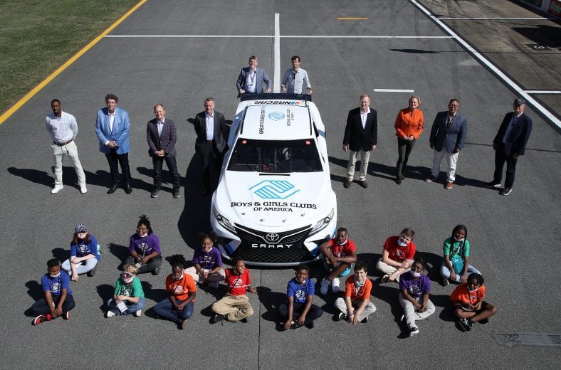 TALLADEGA, ALABAMA - APRIL 25: Front Row (L-R) NASCAR Vice President, Diversity and Inclusion Brandon Thompson, NASCAR Senior Advisor Mike Helton, FOX Sports CEO and Executive Producer Eric Shanks, NASCAR President Steve Phelps, Boys & Girls Clubs of America President and CEO Jim Clark, NASCAR Executive Vice Chair Lesa France Kennedy, Boys & Girls Clubs of America Vice President of Corporate and Partner Relationships Frank Sanchez, NASCAR Chairman and CEO Jim FranceBack Row (L-R) NASCAR Senior Vice President, Communications and Social Responsibility Eric Nyquist, and NASCAR Senior Vice President, Strategic Development Ben Kennedy pose for photos after the announcement of NASCAR's multiyear partnership with the Boys & Girls Clubs that will support the nonprofit’s mission of enabling and enriching the lives of young people prior to the NASCAR Cup Series GEICO 500 at Talladega Superspeedway on April 25, 2021 in Talladega, Alabama. (Photo by Sean Gardner/Getty Images) | Getty Images