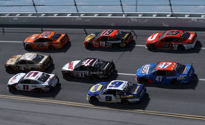 TALLADEGA, ALABAMA - APRIL 25: Denny Hamlin, driver of the #11 FedEx Ground Toyota, Kevin Harvick, driver of the #4 Busch Dog Brew Ford, Joey Logano, driver of the #22 Autotrader Ford, Chase Elliott, driver of the #9 NAPA Auto Parts Chevrolet, Cole Custer, driver of the #41 HaasTooling.com Ford, Martin Truex Jr., driver of the #19 Bass Pro Toyota, and Bubba Wallace, driver of the #23 DoorDash Toyota, race during the NASCAR Cup Series GEICO 500 at Talladega Superspeedway on April 25, 2021 in Talladega, Alabama. (Photo by Sean Gardner/Getty Images) | Getty Images