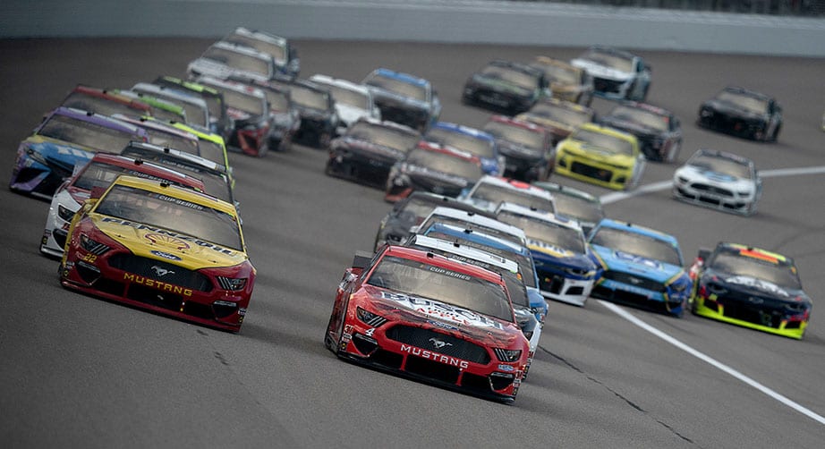 KANSAS CITY, KANSAS - JULY 23: Joey Logano, driver of the #22 Shell Pennzoil Ford, and Kevin Harvick, driver of the #4 Busch Light Apple Ford, lead the field to start the NASCAR Cup Series Super Start Batteries 400 Presented by O'Reilly Auto Parts at Kansas Speedway on July 23, 2020 in Kansas City, Kansas. (Photo by Kyle Rivas/Getty Images) | Getty Images