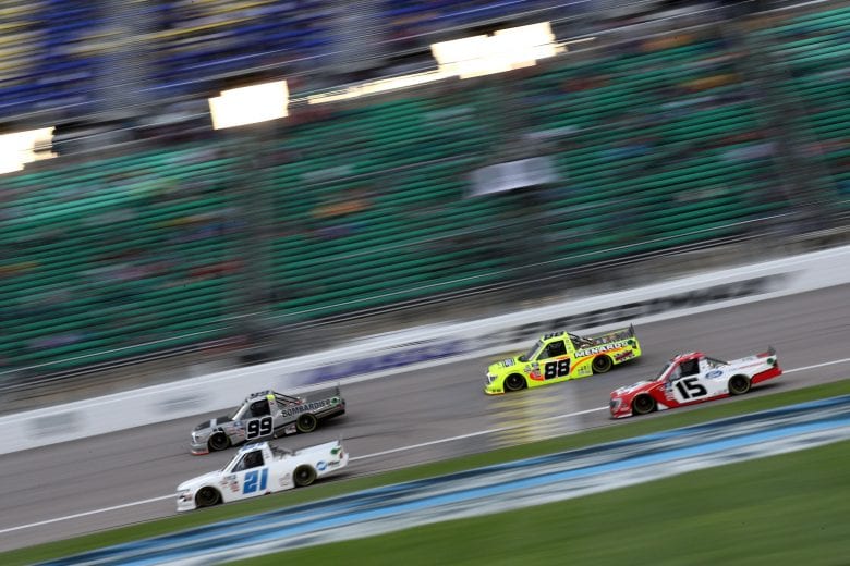 KANSAS CITY, KANSAS - MAY 01: Ben Rhodes, driver of the #99 Bombardier LearJet 75 Toyota, Matt Crafton, driver of the #88 Ideal Door/Menards Toyota, Zane Smith, driver of the #21 Chevrolet, and Tanner Gray, driver of the #15 Ford Performance Ford, race during the NASCAR Camping World Truck Series Wise Power 200 at Kansas Speedway on May 01, 2021 in Kansas City, Kansas. (Photo by Sean Gardner/Getty Images) | Getty Images