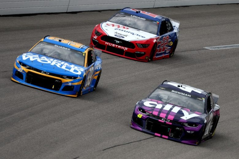 KANSAS CITY, KANSAS - MAY 02: Alex Bowman, driver of the #48 Ally Chevrolet, Daniel Suarez, driver of the #99 Camping World Chevrolet, and Joey Logano, driver of the #22 AAA Insurance Ford, race during the NASCAR Cup Series Buschy McBusch Race 400 at Kansas Speedway on May 02, 2021 in Kansas City, Kansas. (Photo by James Gilbert/Getty Images) | Getty Images