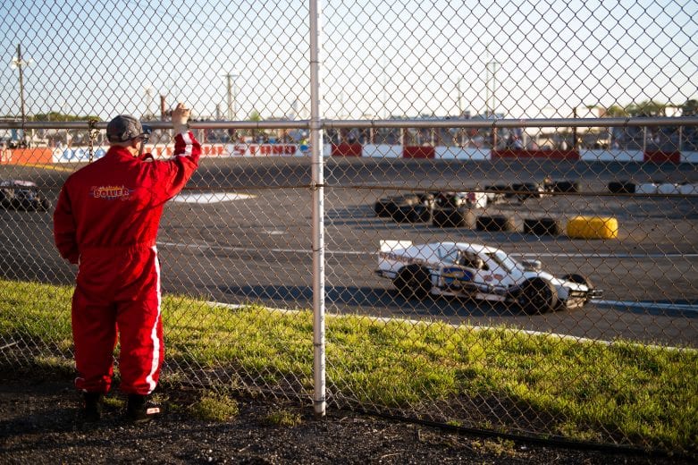 A fan watches cars race during the Miller Lite 200 for the NASCAR Whelen Modified Tour at Riverhead Raceway in Riverhead, New York on May 15, 2021. (Kathryn Riley/NASCAR)