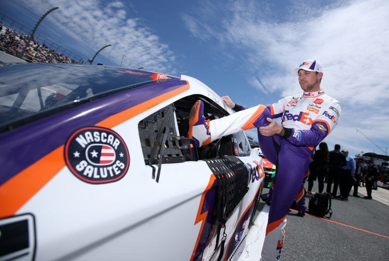 DOVER, DELAWARE - MAY 16: Denny Hamlin, driver of the #11 FedEx Office Toyota, gets into his car during the NASCAR Cup Series Drydene 400 at Dover International Speedway on May 16, 2021 in Dover, Delaware. (Photo by Sean Gardner/Getty Images) | Getty Images