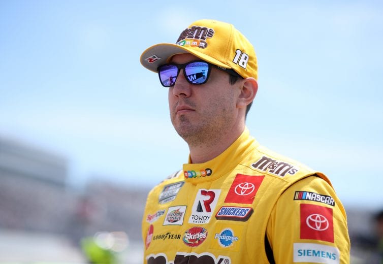 DOVER, DELAWARE - MAY 16: Kyle Busch, driver of the #18 M&M's Mix Toyota, walks the grid during the NASCAR Cup Series Drydene 400 at Dover International Speedway on May 16, 2021 in Dover, Delaware. (Photo by Sean Gardner/Getty Images) | Getty Images