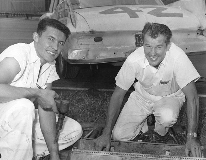 1959:  Richard Petty (L) and his father Lee Petty take a break for a photo at a NASCAR Cup event. (Photo by ISC Images & Archives via Getty Images)