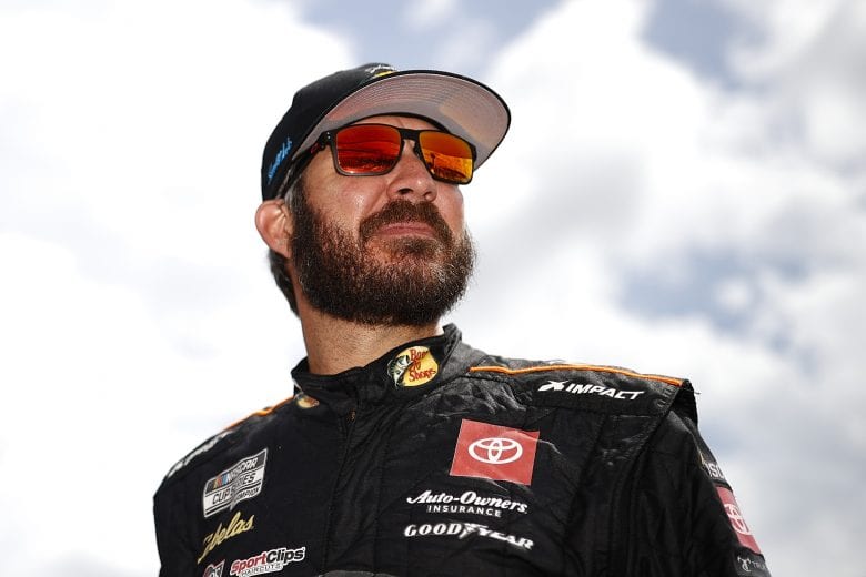 CONCORD, NORTH CAROLINA - MAY 29: Martin Truex Jr., driver of the #19 Bass Pro Shops Red White Blue Toyota, walks the grid during qualifying for the NASCAR Cup Series Coca-Cola 600 at Charlotte Motor Speedway on May 29, 2021 in Concord, North Carolina. (Photo by Jared C. Tilton/Getty Images) | Getty Images