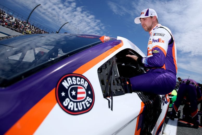 DOVER, DELAWARE - MAY 16: Denny Hamlin, driver of the #11 FedEx Office Toyota, gets into his car during the NASCAR Cup Series Drydene 400 at Dover International Speedway on May 16, 2021 in Dover, Delaware. (Photo by Sean Gardner/Getty Images) | Getty Images