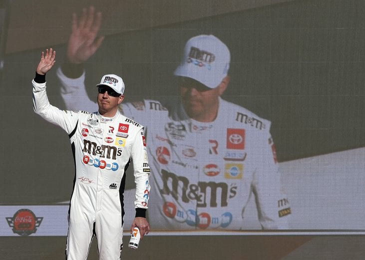 CONCORD, NORTH CAROLINA - MAY 30: Kyle Busch, driver of the #18 M&M's Red White & Blue Toyota, waves to fans during prerace ceremonies prior to the NASCAR Cup Series Coca-Cola 600 at Charlotte Motor Speedway on May 30, 2021 in Concord, North Carolina. (Photo by Brian Lawdermilk/Getty Images) | Getty Images