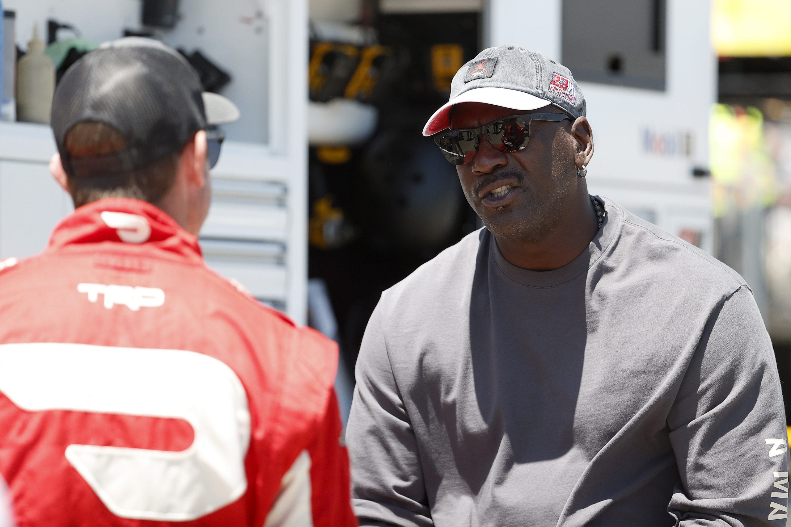 SONOMA, CALIFORNIA - JUNE 06: NBA Hall of Famer Michael Jordan and co-owner of 23XI Racing speaks to a crew member in the #23 DoorDash Toyota pit area prior to the NASCAR Cup Series Toyota/Save Mart 350 at Sonoma Raceway on June 06, 2021 in Sonoma, California. (Photo by Maddie Meyer/Getty Images) | Getty Images