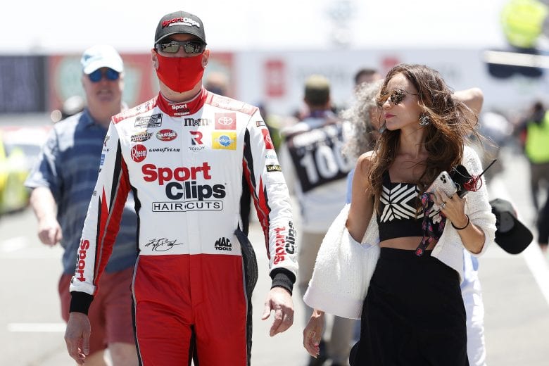 SONOMA, CALIFORNIA - JUNE 06: Kyle Busch, driver of the #18 Sport Clips Toyota, and wife Samantha walk the grid prior to the NASCAR Cup Series Toyota/Save Mart 350 at Sonoma Raceway on June 06, 2021 in Sonoma, California. (Photo by Maddie Meyer/Getty Images) | Getty Images