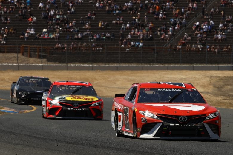 SONOMA, CALIFORNIA - JUNE 06: Bubba Wallace, driver of the #23 DoorDash Toyota, and Martin Truex Jr., driver of the #19 Bass Pro Toyota, race during the NASCAR Cup Series Toyota/Save Mart 350 at Sonoma Raceway on June 06, 2021 in Sonoma, California. (Photo by Maddie Meyer/Getty Images) | Getty Images