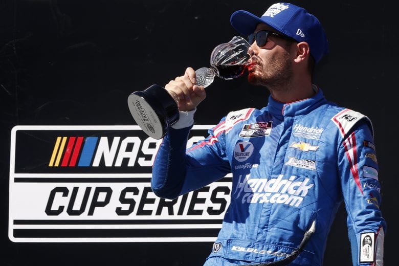 SONOMA, CALIFORNIA - JUNE 06: Kyle Larson, driver of the #5 HendrickCars.com Chevrolet, celebrates in victory lane by drinking wine after winning the NASCAR Cup Series Toyota/Save Mart 350 at Sonoma Raceway on June 06, 2021 in Sonoma, California. (Photo by Maddie Meyer/Getty Images) | Getty Images