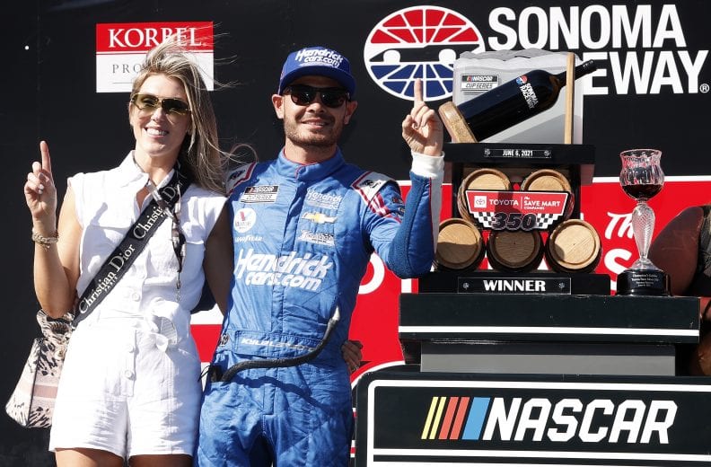 SONOMA, CALIFORNIA - JUNE 06: Kyle Larson, driver of the #5 HendrickCars.com Chevrolet, and wife, Katelyn celebrate in victory lane after winning the NASCAR Cup Series Toyota/Save Mart 350 at Sonoma Raceway on June 06, 2021 in Sonoma, California. (Photo by Maddie Meyer/Getty Images) | Getty Images