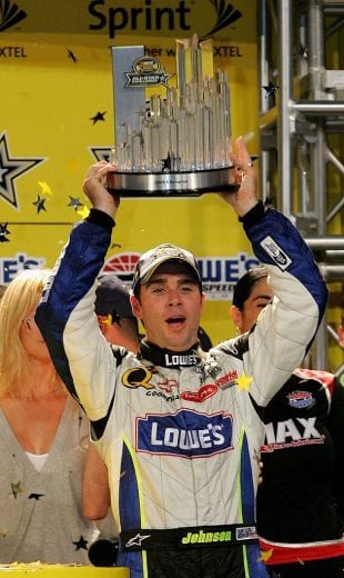 CONCORD, NC - MAY 20: Jimmie Johnson, driver of the #48 Lowe's Chevrolet, holds up the trophy after winning the NASCAR Nextel Cup Series All-Star Challenge on May 20, 2006 at Lowe's Motor Speedway in Concord, North Carolina. (Photo by Streeter Lecka/Getty Images) | Getty Images