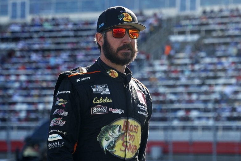 CONCORD, NORTH CAROLINA - MAY 30: Martin Truex Jr., driver of the #19 Bass Pro Shops Red White Blue Toyota, walks the grid prior to the NASCAR Cup Series Coca-Cola 600 at Charlotte Motor Speedway on May 30, 2021 in Concord, North Carolina. (Photo by Maddie Meyer/Getty Images) | Getty Images