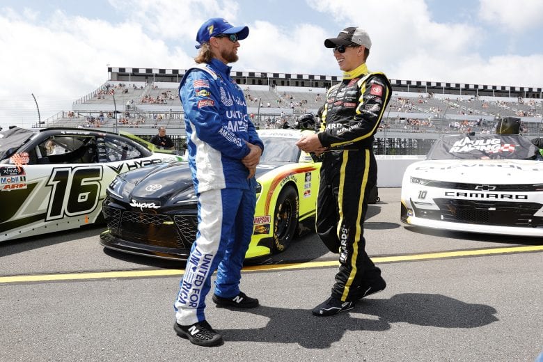 LONG POND, PENNSYLVANIA - JUNE 27: Brandon Jones, driver of the #19 Menards/Pelonis Toyota, (R) and a crew-member of the #7 Hellmann's 100% Recycled Chevrolet, talk on the grid prior to the NASCAR Xfinity Series Pocono Green 225 Recycled by J.P. Mascaro & Sons at Pocono Raceway on June 27, 2021 in Long Pond, Pennsylvania. (Photo by Tim Nwachukwu/Getty Images) | Getty Images