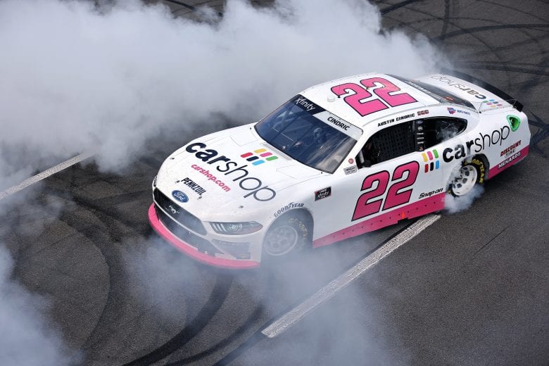 LONG POND, PENNSYLVANIA - JUNE 27: Austin Cindric, driver of the #22 Car Shop Ford, celebrates with a burnout after winning the NASCAR Xfinity Series Pocono Green 225 Recycled by J.P. Mascaro & Sons at Pocono Raceway on June 27, 2021 in Long Pond, Pennsylvania. (Photo by James Gilbert/Getty Images) | Getty Images