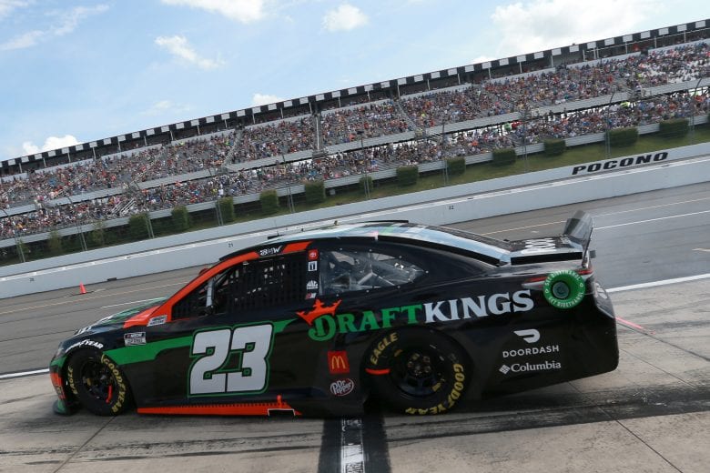 LONG POND, PENNSYLVANIA - JUNE 27: Bubba Wallace, driver of the #23 DraftKings Toyota, exits pit road during the NASCAR Cup Series Explore the Pocono Mountains 350 at Pocono Raceway on June 27, 2021 in Long Pond, Pennsylvania. (Photo by Sean Gardner/23XI Racing via Getty Images)