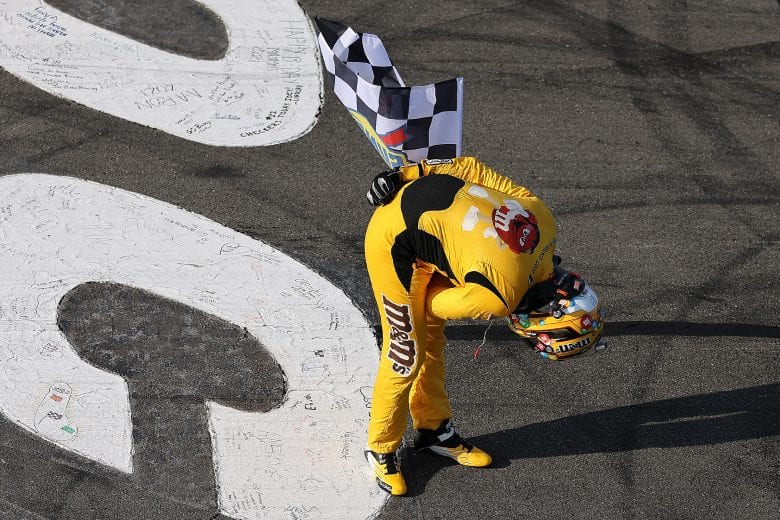 LONG POND, PENNSYLVANIA - JUNE 27: Kyle Busch, driver of the #18 M&M's Mini's Toyota, takes a bow after winning the NASCAR Cup Series Explore the Pocono Mountains 350 at Pocono Raceway on June 27, 2021 in Long Pond, Pennsylvania. (Photo by James Gilbert/Getty Images) | Getty Images