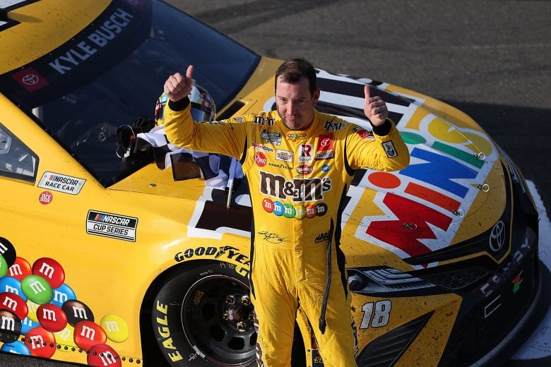 LONG POND, PENNSYLVANIA - JUNE 27: Kyle Busch, driver of the #18 M&M's Mini's Toyota, gives fans a thumbs up after winning the NASCAR Xfinity Series Pocono Green 225 Recycled by J.P. Mascaro & Sons at Pocono Raceway on June 27, 2021 in Long Pond, Pennsylvania. (Photo by James Gilbert/Getty Images) | Getty Images