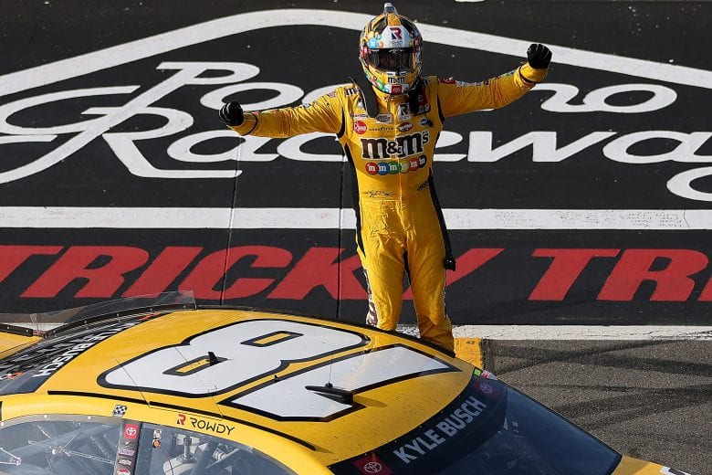 LONG POND, PENNSYLVANIA - JUNE 27: Kyle Busch, driver of the #18 M&M's Mini's Toyota, celebrates after winning the NASCAR Cup Series Explore the Pocono Mountains 350 at Pocono Raceway on June 27, 2021 in Long Pond, Pennsylvania. (Photo by James Gilbert/Getty Images) | Getty Images