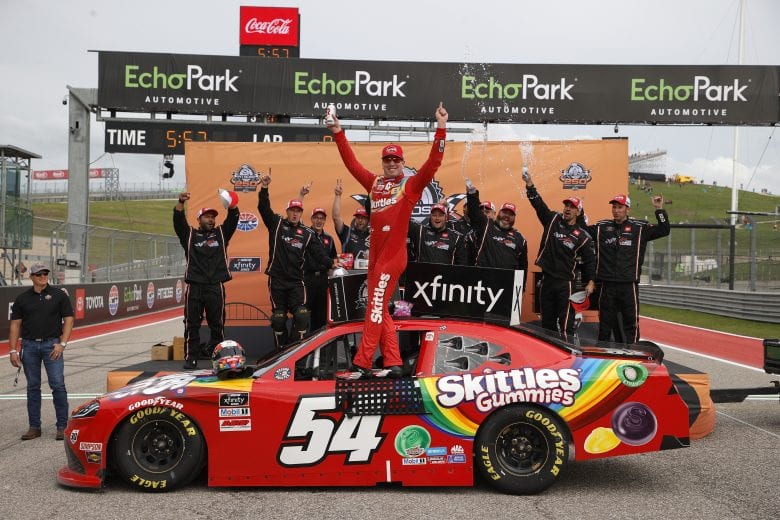 AUSTIN, TEXAS - MAY 22: Kyle Busch, driver of the #54 Skittles Gummies Toyota, and crew celebrate in victory lane after winning the NASCAR Xfinity Series Pit Boss 250 at Circuit of The Americas on May 22, 2021 in Austin, Texas. (Photo by Chris Graythen/Getty Images) | Getty Images