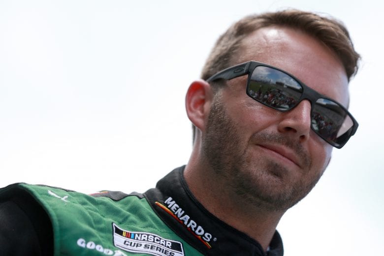 HAMPTON, GEORGIA - JULY 11: Matt DiBenedetto, driver of the #21 Menards/Quaker State Ford, walks the stage during pre-race ceremonies prior to the NASCAR Cup Series Quaker State 400 presented by Walmart at Atlanta Motor Speedway on July 11, 2021 in Hampton, Georgia. (Photo by Sean Gardner/Getty Images) | Getty Images