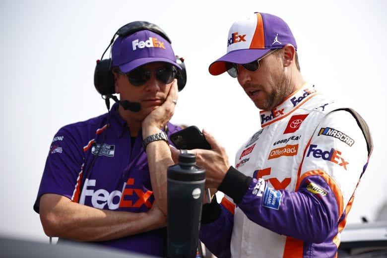ELKHART LAKE, WISCONSIN - JULY 04: Denny Hamlin, driver of the #11 FedEx Freight Toyota, and crew chief Christopher Gabehart talk on the grid during qualifying for the NASCAR Cup Series Jockey Made in America 250 Presented by Kwik Trip at Road America on July 04, 2021 in Elkhart Lake, Wisconsin. (Photo by Jared C. Tilton/Getty Images) | Getty Images
