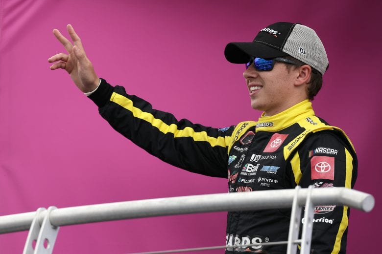 LOUDON, NEW HAMPSHIRE - JULY 17: Brandon Jones, driver of the #19 Menards/Jeld-Wen Toyota, waves to fans on stage during pre-race ceremonies prior to the NASCAR Xfinity Series Ambetter Get Vaccinated 200 at New Hampshire Motor Speedway on July 17, 2021 in Loudon, New Hampshire. (Photo by James Gilbert/Getty Images) | Getty Images