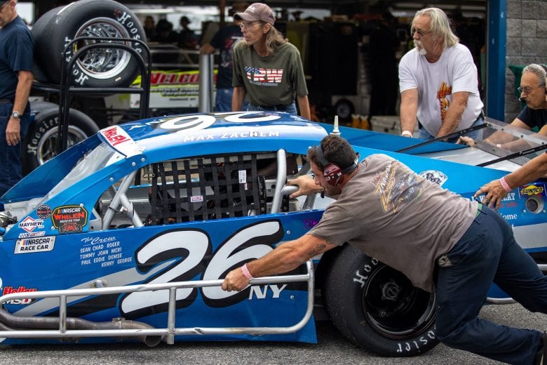 Max Zachem, driver of the #26 Lakeland Landscape Supply/LI Wood Heat Chevrolet, is pushed to the garage during the Whelen 100 for the NASCAR Whelen Modified Series at New Hampshire Motor Speedway in Loudon, New Hampshire on July 17, 2021. (Paul Rutherford/NASCAR)