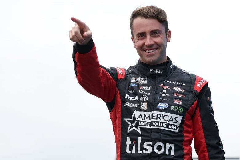 LOUDON, NEW HAMPSHIRE - JULY 18: James Davison, driver of the #15 Chevrolet, walks on stage during pre-race ceremonies prior to the NASCAR Cup Series Foxwoods Resort Casino 301 at New Hampshire Motor Speedway on July 18, 2021 in Loudon, New Hampshire. (Photo by James Gilbert/Getty Images) | Getty Images
