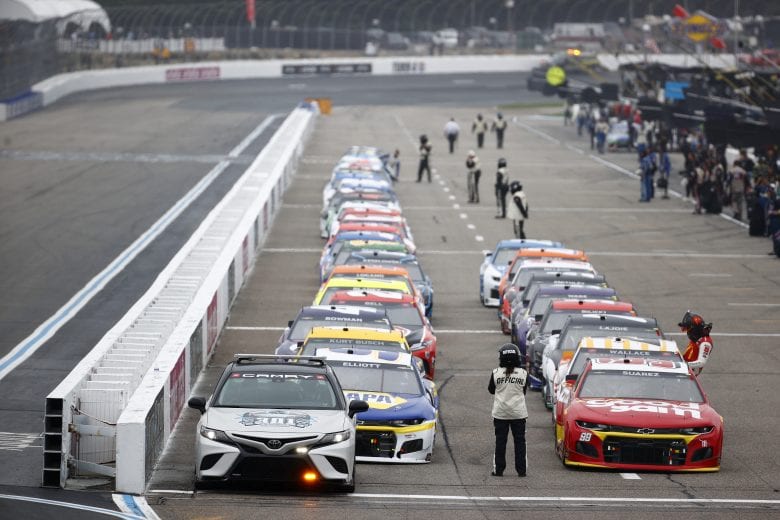 LOUDON, NEW HAMPSHIRE - JULY 18: Cars wait on the grid under a rain delay during the NASCAR Cup Series Foxwoods Resort Casino 301 at New Hampshire Motor Speedway on July 18, 2021 in Loudon, New Hampshire. (Photo by Jared C. Tilton/Getty Images) | Getty Images