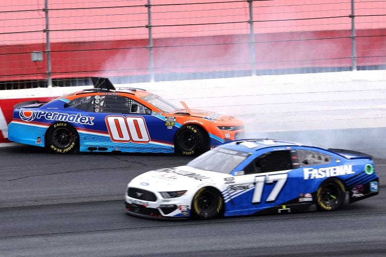 LOUDON, NEW HAMPSHIRE - JULY 18: Quin Houff, driver of the #00 Permatex Chevrolet, spins into the wall as Chris Buescher, driver of the #17 Fastenal Ford, drives past during the NASCAR Cup Series Foxwoods Resort Casino 301 at New Hampshire Motor Speedway on July 18, 2021 in Loudon, New Hampshire. (Photo by James Gilbert/Getty Images) | Getty Images
