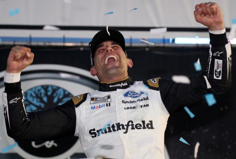 LOUDON, NEW HAMPSHIRE - JULY 18: Aric Almirola, driver of the #10 Smithfield Ford, celebrates in victory lane after winning the NASCAR Cup Series Foxwoods Resort Casino 301 at New Hampshire Motor Speedway on July 18, 2021 in Loudon, New Hampshire. (Photo by James Gilbert/Getty Images) | Getty Images
