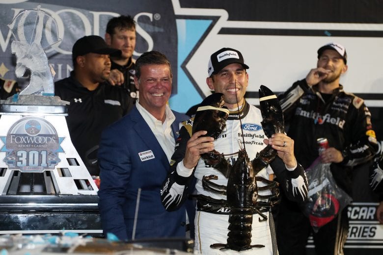 LOUDON, NEW HAMPSHIRE - JULY 18: Aric Almirola, driver of the #10 Smithfield Ford, celebrates in victory lane after winning the NASCAR Cup Series Foxwoods Resort Casino 301 at New Hampshire Motor Speedway on July 18, 2021 in Loudon, New Hampshire. (Photo by James Gilbert/Getty Images) | Getty Images