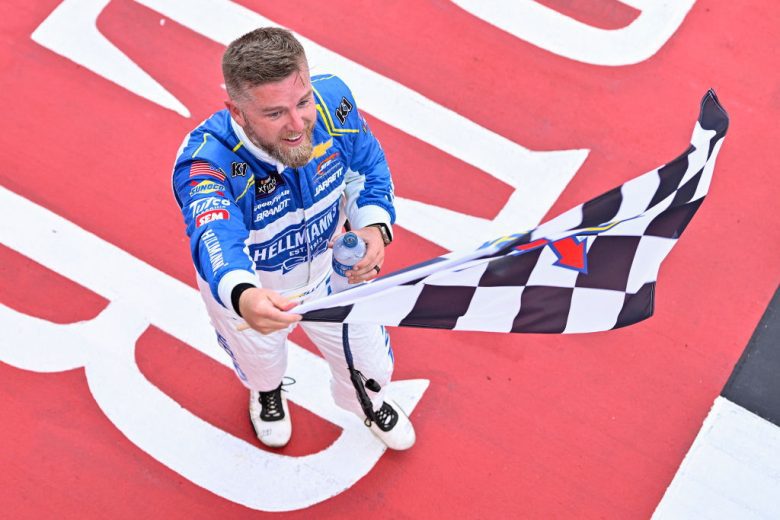 Justin Allgaier waves the checkered flag following his NASCAR Xfinity Series victory at Michigan International Speedway.