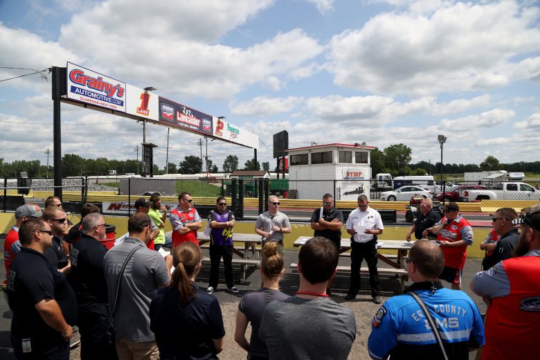 Safety crew members during a meeting prior to the Nu Way Auto Parts 150 for the NASCAR Whelen Modified Tour at New York International Raceway Park in Lancaster, New York on July 31, 2021. (Bryan Bennett/NASCAR)