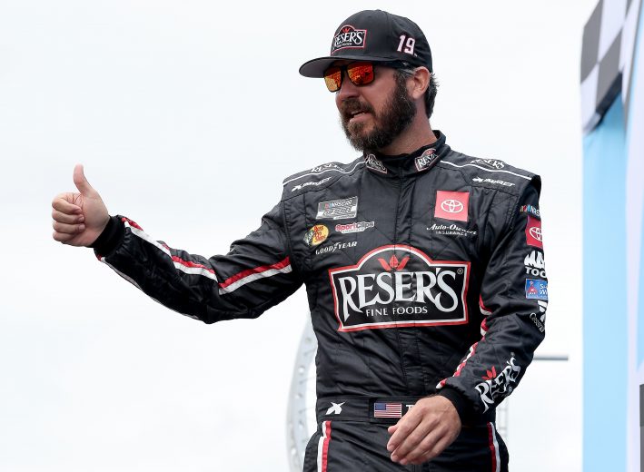 LOUDON, NEW HAMPSHIRE - JULY 18: Martin Truex Jr., driver of the #19 Resers Fine Foods #LetsPicnic Toyota, gives a thumbs up to fans on stage during pre-race ceremonies prior to the NASCAR Cup Series Foxwoods Resort Casino 301 at New Hampshire Motor Speedway on July 18, 2021 in Loudon, New Hampshire. (Photo by James Gilbert/Getty Images) | Getty Images