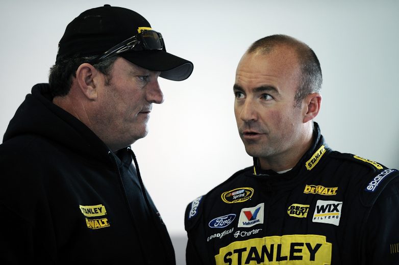 DAYTONA BEACH, FL - JANUARY 13: Todd Parrott (L), crew chief of the #9 Stanley Tools Ford, and Marcos Ambrose, driver of the #9 Stanley Tools Ford, convers in the garage area during Daytona Preseason Thunder at Daytona International Speedway on January 13, 2012 in Daytona Beach, Florida. (Photo by Jared C. Tilton/Getty Images for NASCAR) | Getty Images