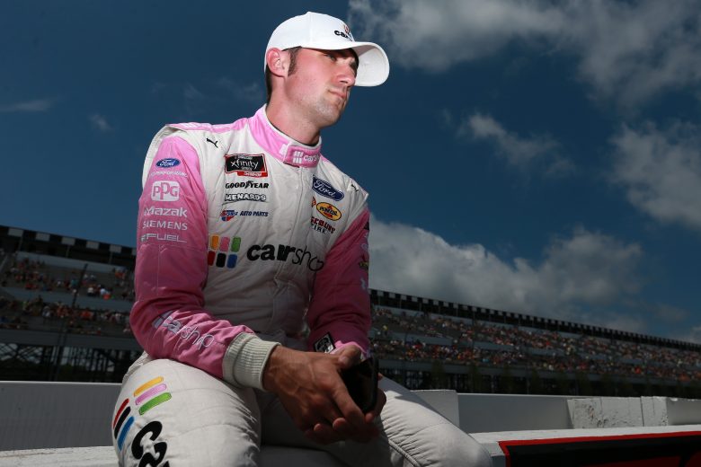 LONG POND, PENNSYLVANIA - JUNE 27: Austin Cindric, driver of the #22 Car Shop Ford, waits on the grid prior to the NASCAR Xfinity Series Pocono Green 225 Recycled by J.P. Mascaro & Sons at Pocono Raceway on June 27, 2021 in Long Pond, Pennsylvania. (Photo by Sean Gardner/Getty Images) | Getty Images