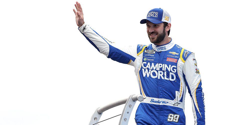 LOUDON, NEW HAMPSHIRE - JULY 18: Daniel Suarez, driver of the #99 Good Sam Chevrolet, waves to fans on stage during pre-race ceremonies prior to the NASCAR Cup Series  Foxwoods Resort Casino 301 at New Hampshire Motor Speedway on July 18, 2021 in Loudon, New Hampshire. (Photo by James Gilbert/Getty Images) | Getty Images